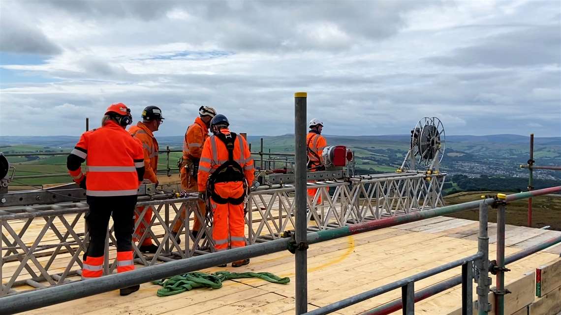 Teams moving the winch system into place on top of Cowburn Tunnel ventilation shaft