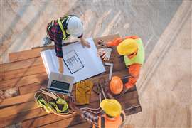 Construction workers looking at documents