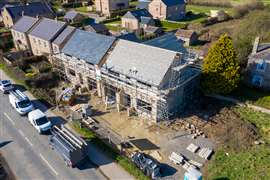 Aerial photo of the UK village of Wetherby in Yorkshire showing building construction work being done on a property in the village with scaffolding up at the property