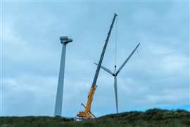 A crane lowers a turbine component at Hagshaw wind farm