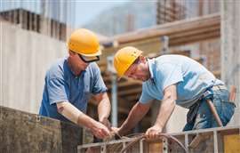 Two construction workers at work