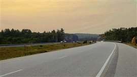 Provincial Highway 69 presses northward through the wilderness of Northern Ontario, Canada, as seen near the community of Burwash on a July evening.