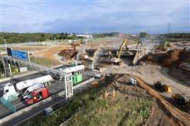 Demolition excavators taking down the two-span M42 bridge