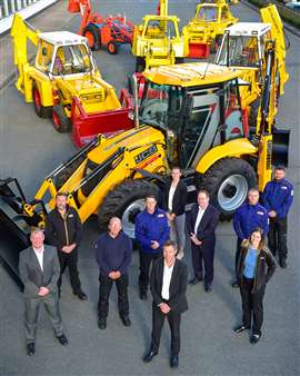 Employees celebrate the JCB backhoe's 70th birthday