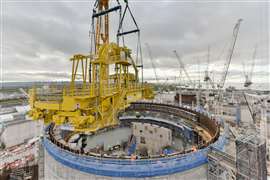 yellow polar crane runs on a circular track inside the reactor dome