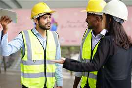 Three construction workers in a dispute.