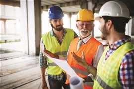 three men chatting in construction work wear