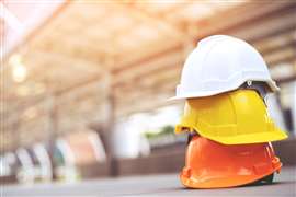 Three hard hats stacked on top of each other