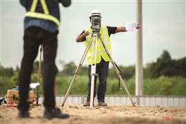 Operators behind surveying equipment