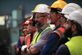 A group of construction workers listening to a training briefing.