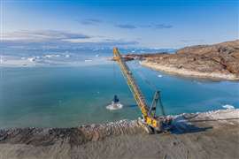 Munck Civil Engineering is using a Liebherr HS8200 duty cycle crawler crane to dredge the seabed in Ilulissat,  Greenland, ahead of the construction of a new airport