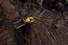 Aerial view of a dumper on a muddy construction site.