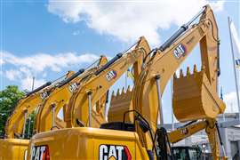 New yellow Caterpillar excavators arranged in a line.