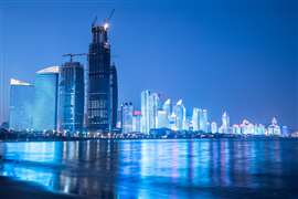 Qingdao City, China at night, with skyscrapers next to water