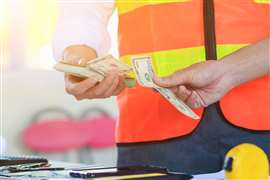 Engineers and Foreman are calculating workers' expenses and overtime to pay workers compensation and overtime each month. Foreman holds cash in hand to pay workers as compensation