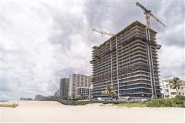 Formwork and tower cranes at the construction site for Casamar in Pomona Beach, Florida, US