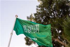 The national flag of Saudi Arabia against a clear sky