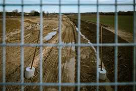 View of the construction site of the Toulouse-Castres A69 motorway through a grid 