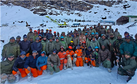Rescue workers pictured after they spent 3 days working to find 54 construction whos camp was hit by an avalance in the Himalayas