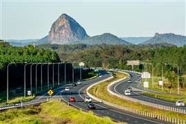 The Bruce Highway, looking south, with Tibrogargan of the the Glasshouse Mountains in the background; Sunshine Coast Hinterland, Queensland, Australia.