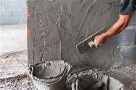 cement being put on a wall