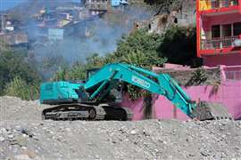 A turquoise Kobelco crawler excavator in Rishikesh, Uttarakhand, India
