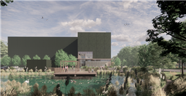View across the natural pond from the main access road towards the main entrance and car park with secure bike storage in the foreground. ©Feilden Clegg Bradley Studios architects