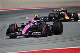 A pink BWT Alpine Formula One racing car on a track
