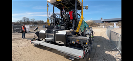A Vögele Dash paver equipped with Trimble sensing technology. The unit requires an operator to oversee the pave trajectory but requires little manual operation. (Image: Mitchell Keller)