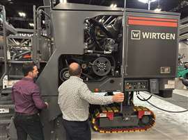Attendees to World of Asphalt 2025 check out a Wirtgen Group roadworks machine on the expo floor. (Image: Mitchell Keller)