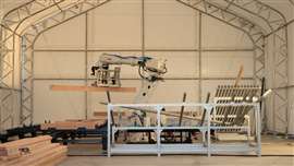 Ein Roboterarm von ABB arbeitet in einer Mikrofabrik. Anlagen wie diese des kalifornischen Unternehmens Cosmic Buildings helfen beim Bau von Häusern für Waldbrandopfer. Bild: ABB