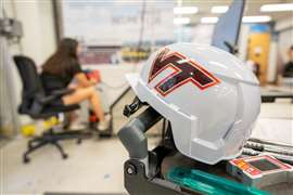 A white construction helmet with "VT" Virginia Tech branding