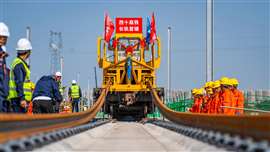 The first pair of 500-metre-long steel rails are laid onto a ballastless track slab between Xi'an East and Lantian in China for the Xi'an-Shiyan high-speed railway. China Railway Fourth Engineering Bureau, a subsidiary of China Railway Group Limited (CREC) is primarily responsible for track laying on the entire line, totalling 512 kilometres. (Image courtesy of China Railway Group).