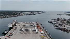 A drone view shows rotor blades and other parts for the ongoing construction of the Revolution Wind offshore wind turbine farm, staged on the State Pier in New London, Connecticut, USA. The Revolution Wind project, which is a joint venture between the Danish company Orsted and Skyborn Renewables, is located 15 miles off the coast of Rhode Island and is 80% complete with all offshore foundations in place and 45 of 65 wind turbines installed. Earlier this month, a federal judge ruled that Ørsted can restart the nearly-complete project after Revolution Wind sought a temporary injunction to lift a stop-work order issued by the Trump administration on 22 August. (Image: Reuters/Brian Snyder).