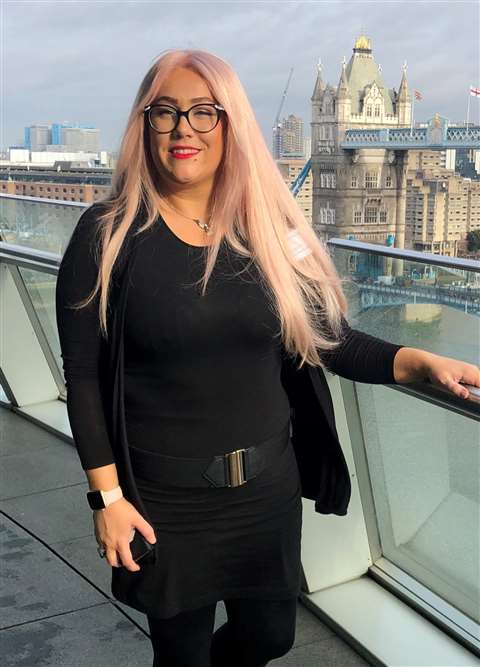 Katie Kelleher standing in front of Tower Bridge in London