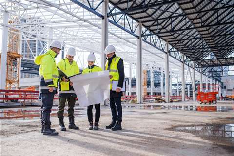 Engineers examine plans on a construction site