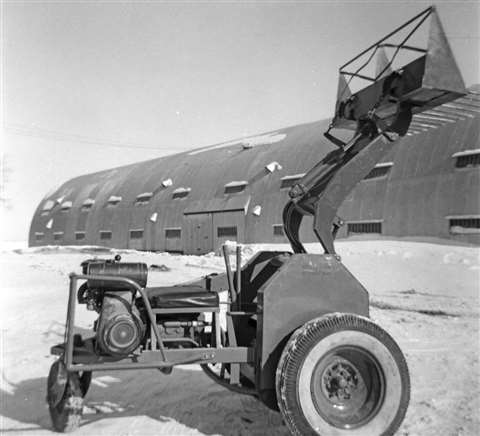 Black and white photo of one of the Keller brothers' original three-wheeled loaders of the type on display at the museum